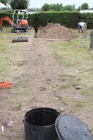 Plate 63. Churchyard Trench no 4. for the foul sewer pipe, part filled with manhole. The manhole now sits over the tegulae wall F4
